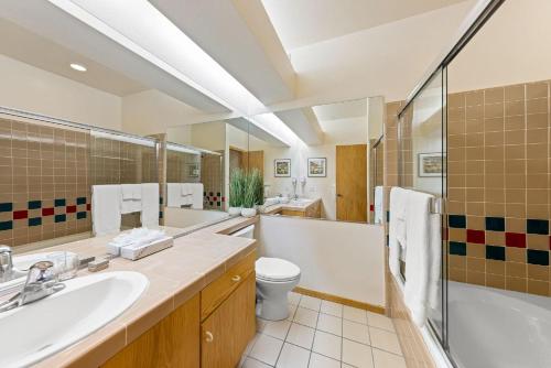 a bathroom with a sink and a tub and a toilet at Studio #253 in Olympic Valley