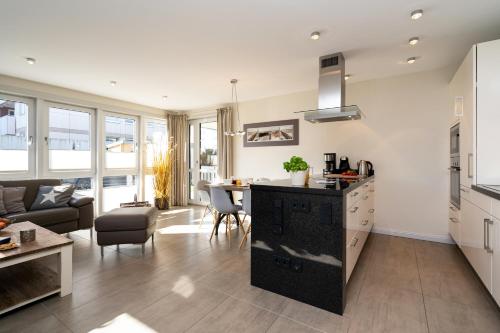 a kitchen and living room with a couch and a table at Sölring Lek Westerland in Westerland (Sylt)
