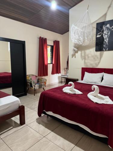 a bedroom with a bed with swans on it at Recanto da Serra in Pardinho