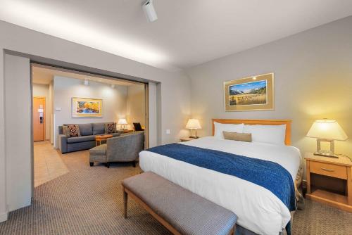 a hotel room with a large bed and a couch at Studio #255 in Olympic Valley