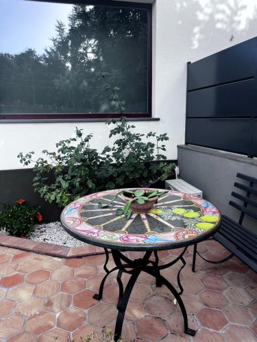a table with a mosaic top on a patio at Sciara Casa Vacanze in Pedara