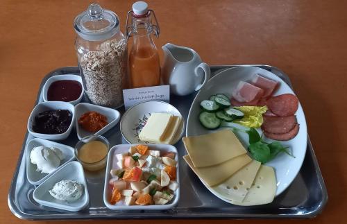 a tray of food with cheese and other food items at Einfachlosmachen Turmzimmer 