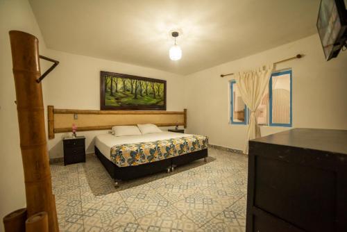 a bedroom with a bed in the middle of it at Eco Hotel Terrabella in Santa Elena