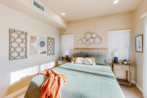 a bedroom with a bed and two windows at Bay Park Villa in San Diego