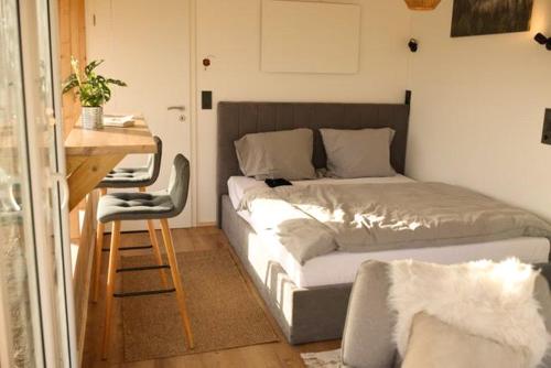 a bedroom with a bed and a desk and a table and a chair at Nordic Harmony Home - Prignitz 