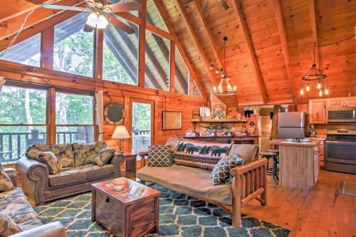 a living room with couches and a kitchen at Majestic View Hideaway in Sevierville