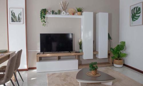 a living room with a flat screen tv on a table at Domus Vivendi Pompeii holiday home free parking in Pompei