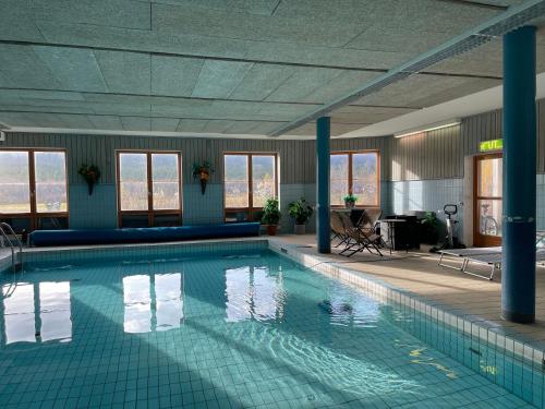 a large swimming pool in a hotel room at Vandrarhemsboende på Ammarnäsgården in Ammarnäs