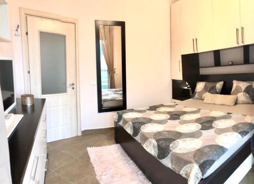 um quarto com uma cama grande e um espelho grande em Family Villa at Gjiri Lalzit em Durrës