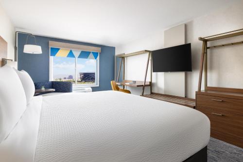 a bedroom with a large white bed and a window at Holiday Inn Express Las Vegas Stadium Area, an IHG Hotel in Las Vegas