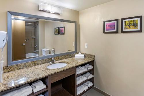 a bathroom with a sink and a mirror at Comfort Inn Layton - Salt Lake City in Layton