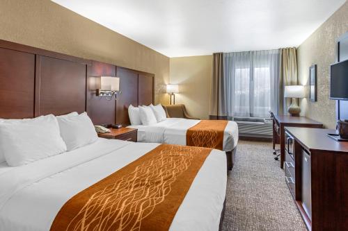 a hotel room with two beds and a desk at Comfort Inn Layton - Salt Lake City in Layton
