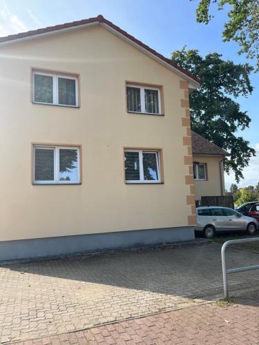 a house with three windows and a car at Pension Wolkenheim 