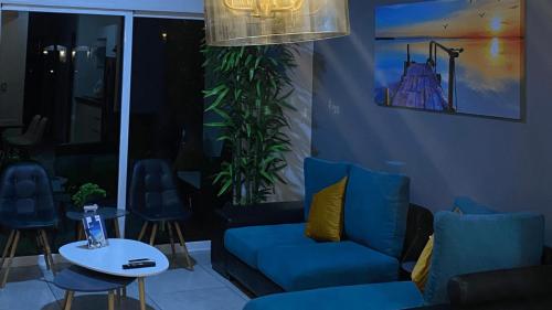 a living room with a blue couch and a table at Pacifika Marina Mazatlán in Mazatlán