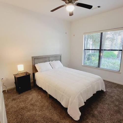 a white bedroom with a bed and a ceiling fan at Fantastic 1-Bedroom Close to Reliant Stadium & Medical Center in Houston