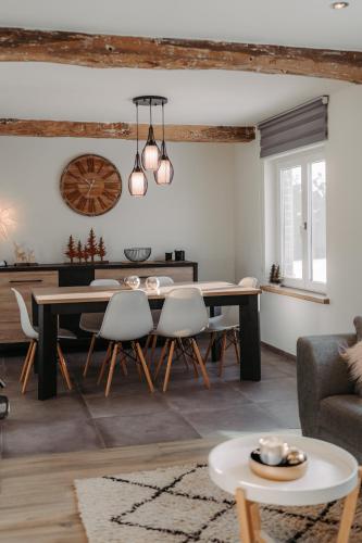 a living room with a dining room table and chairs at Villa ADurbuy avec Jacuzzi in Durbuy