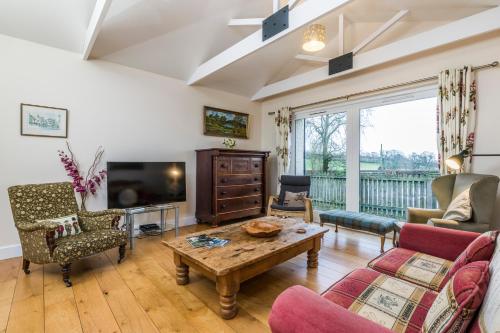 a living room with a couch and a table at Incheoch Farm Granary in Alyth
