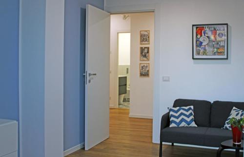 a living room with a couch and a hallway at Casa D'Antò in Petralia Sottana