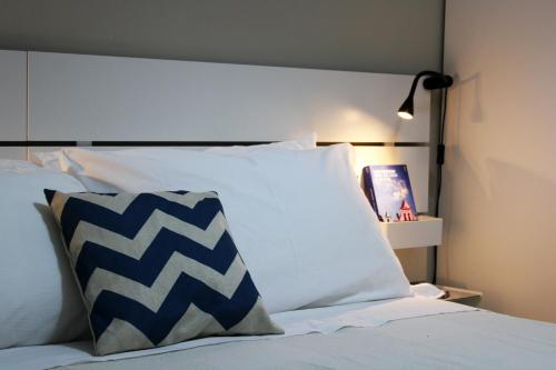 a bed with blue and white pillows on it at Casa D'Antò in Petralia Sottana