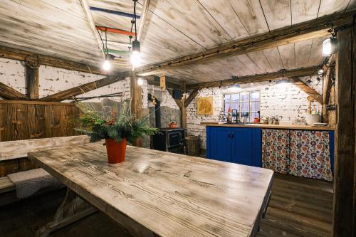 a kitchen with a wooden table in a room at Apartmán V medvědím brlohu in Dolní Lomná