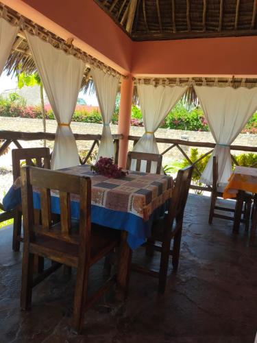 a dining room with a table and some chairs at Samaki Villa in Watamu