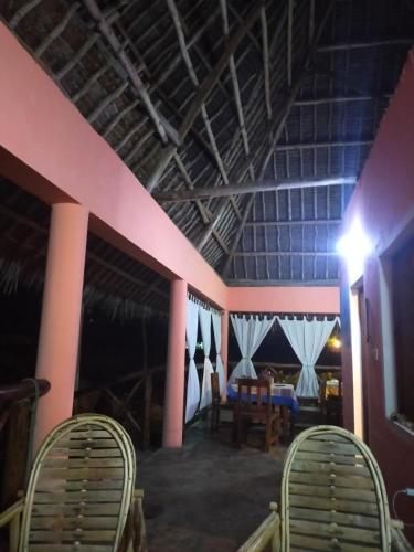 a room with two chairs and a table in it at Samaki Villa in Watamu