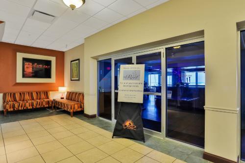a lobby with a sign in the middle of a room at Daytona Beach Resort in Daytona Beach