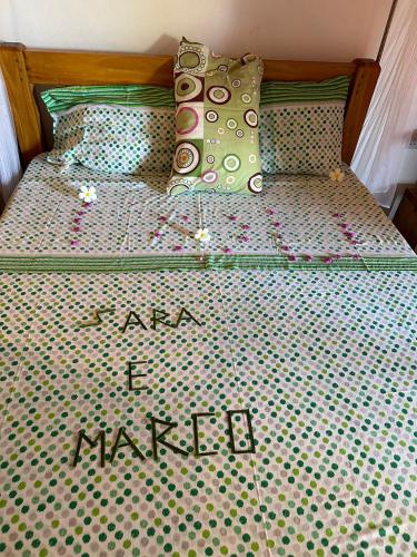 a bed with a mattress with the words and i market on it at Samaki Villa in Watamu