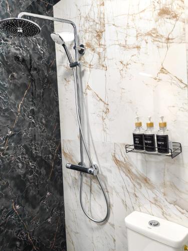 a shower with a glass door in a bathroom at Luxury Apartment/Studio in Plovdiv