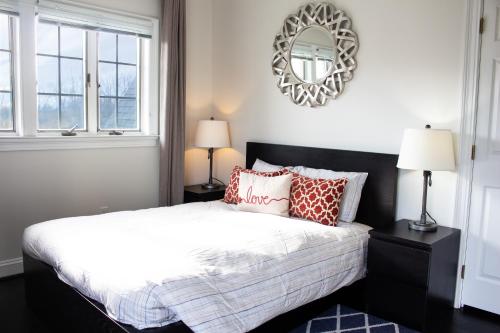 a bedroom with a bed and a mirror on the wall at Hygge, Upscale & Relaxing Luxury in Potomac