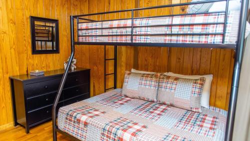 a bedroom with a bunk bed with a wooden wall at Little Smoky Retreat , 3 Bedroom , Close to downtown Gatlinburg AND Pigeon Forge in Gatlinburg
