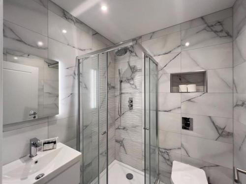 a bathroom with a shower and a sink at Modern 2 Bed Apartment - Allocated Parking in Windsor