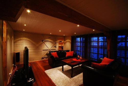 a living room with a couch and a table at Rorbu Suite with sauna and steam. Henningsvær in Henningsvær