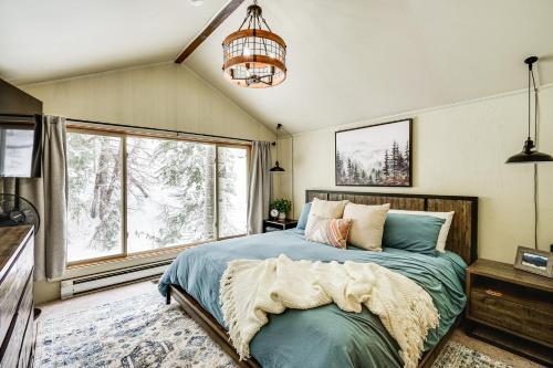 a bedroom with a bed and a large window at Solitude Mountain Cabin Creek-Side View and Hot Tub in Brighton
