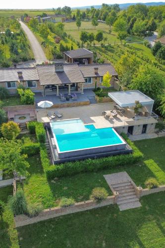 an aerial view of a house with a swimming pool at Lake House by NIVO in Pavlovci