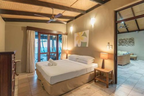 a bedroom with a bed and a ceiling fan at BALA Beach House on ABSOLUTE Beachfront in Newell Beach