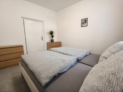 a bedroom with two beds and a dresser and a mirror at Apartmány Plzeň Rolnické náměstí 8 in Plzeň