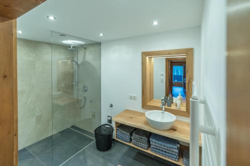 a bathroom with a sink and a shower at Haus Forelle in Inneralpbach