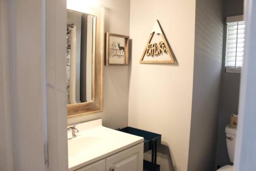 a bathroom with a sink and a mirror and a toilet at Great Outdoors in Lagrange in LaGrange