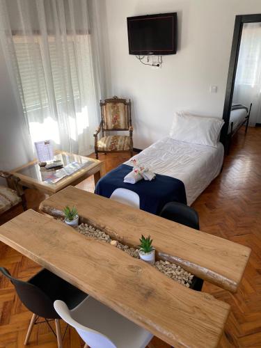 a room with a bed and a table and a bed sidx sidx sidx at Alojamento D. Duarte in São Paio
