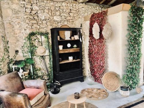 a living room with a couch and a fireplace at Le Mas Réolais in Saint-Sève