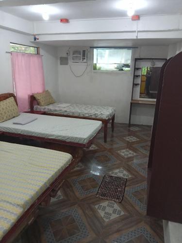 a room with tables and chairs in a room at Czar's Place in Siquijor