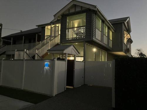 a house with a fence in front of a gate at Entire Upper Floor 1 Bedroom in Brisbane