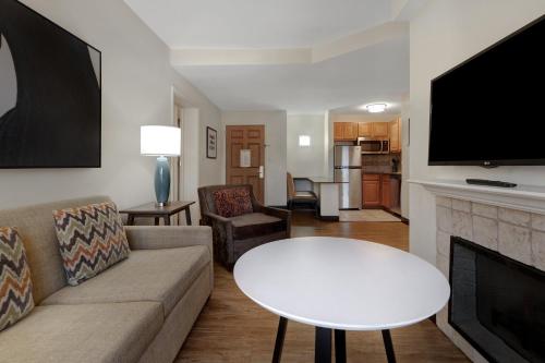 a living room with a couch and a table at Staybridge Suites Tallahassee I-10 East by IHG in Tallahassee