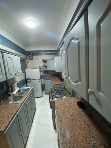 a small kitchen with a stove and refrigerator at مهندسين in Cairo