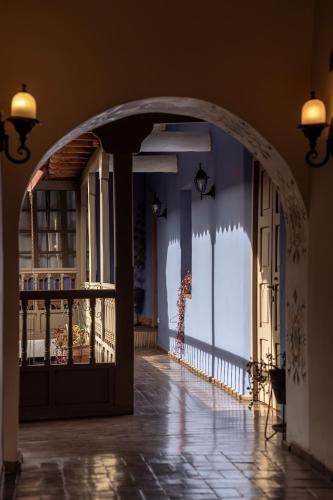 an archway leading into a room with a door at Tambo del Arriero Hotel Boutique in Cusco