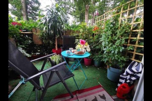 a patio with a table and a bunch of plants at Lovely room,Rambouillet in Rambouillet