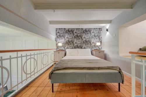 a bedroom with a bed and two night stands at Casa Marie Studio Maisonette in Cospicua