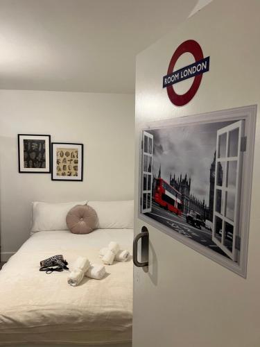 a bedroom with a bed with a train picture on the door at Lovely Double Rooms in Euston & Square in London