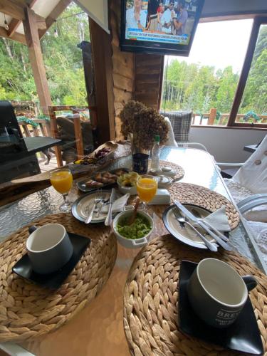 a dining room table with food and drinks on it at Habitación en Casa Cumbres del Lago in Puerto Varas